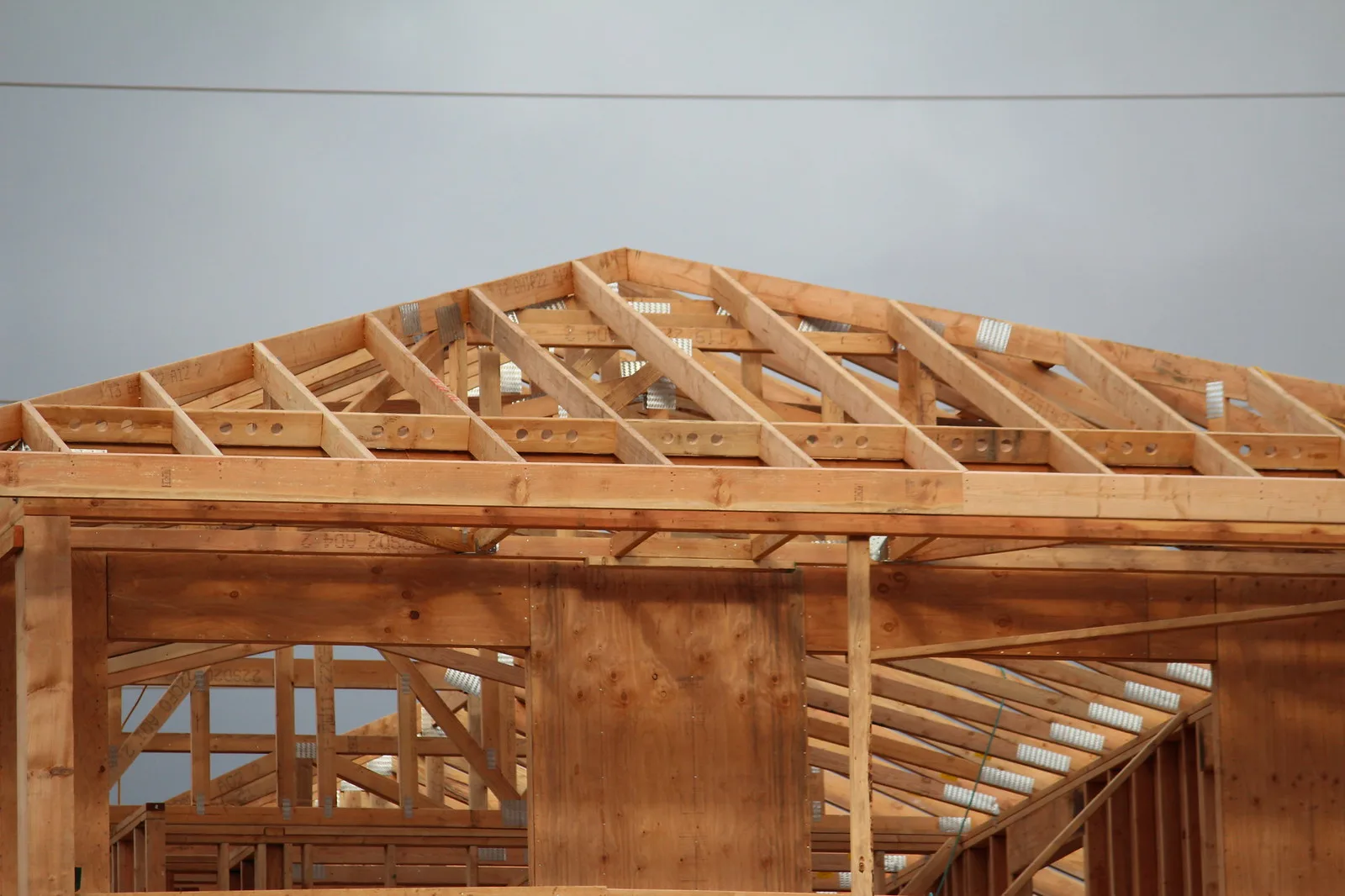 Roof trusses and wall framing on a new house under construction.