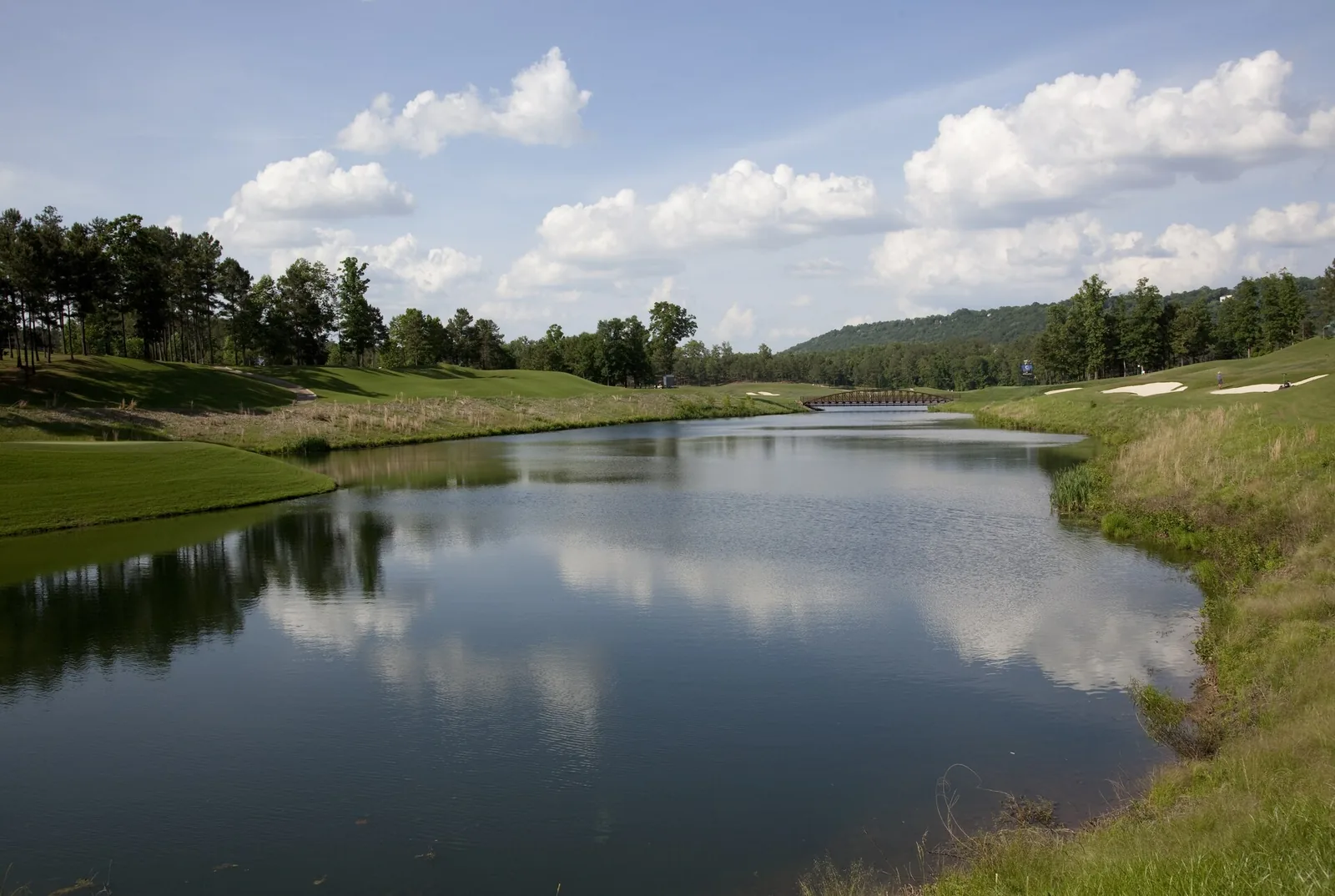 Clouds reflected in a lake along the fairways of the Ross Bridge course on the Robert Trent Jones Golf Trail in Hoover.