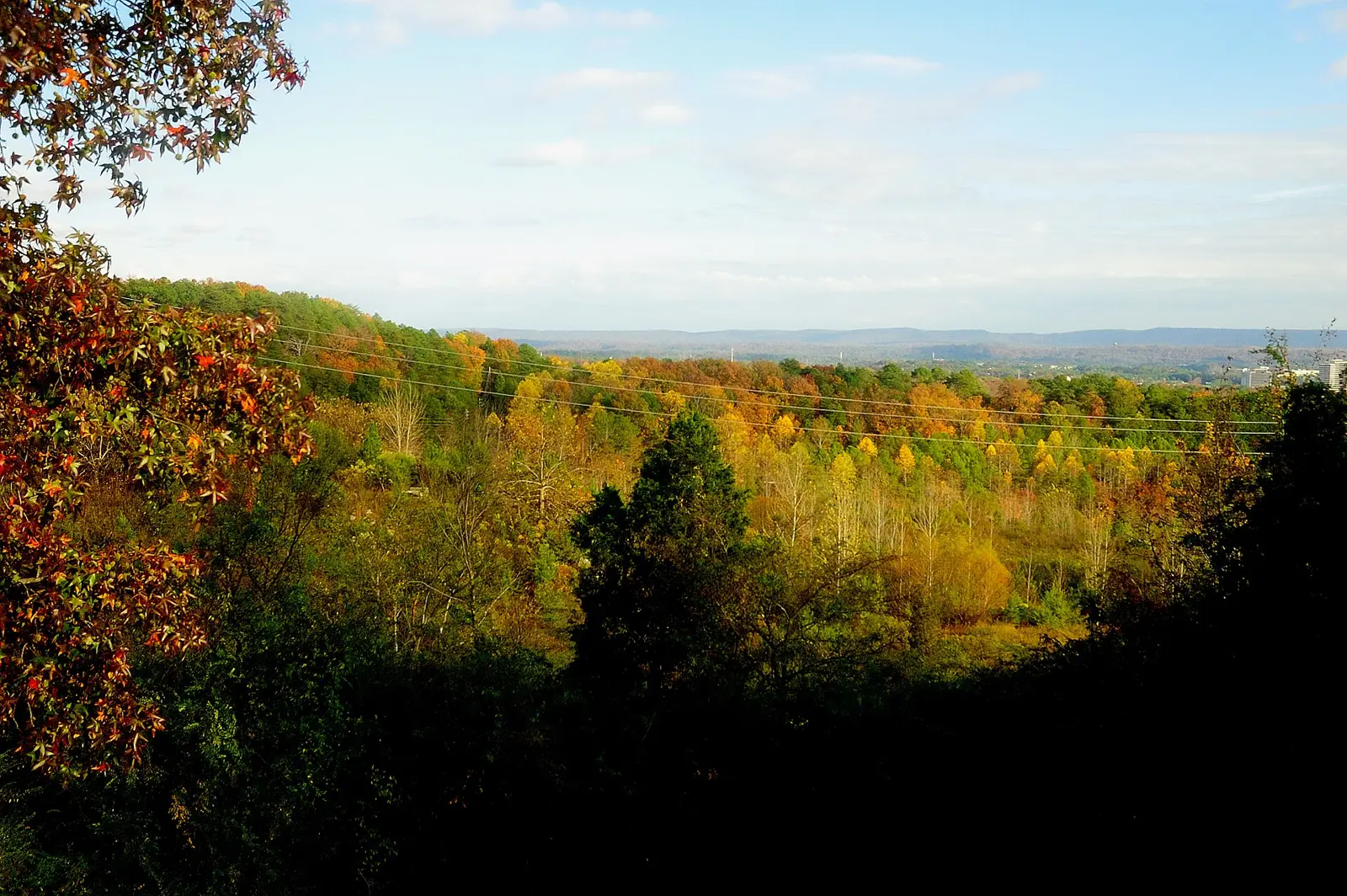 Fall color over the wooded ridges of Hoover, seen from a home's back deck.