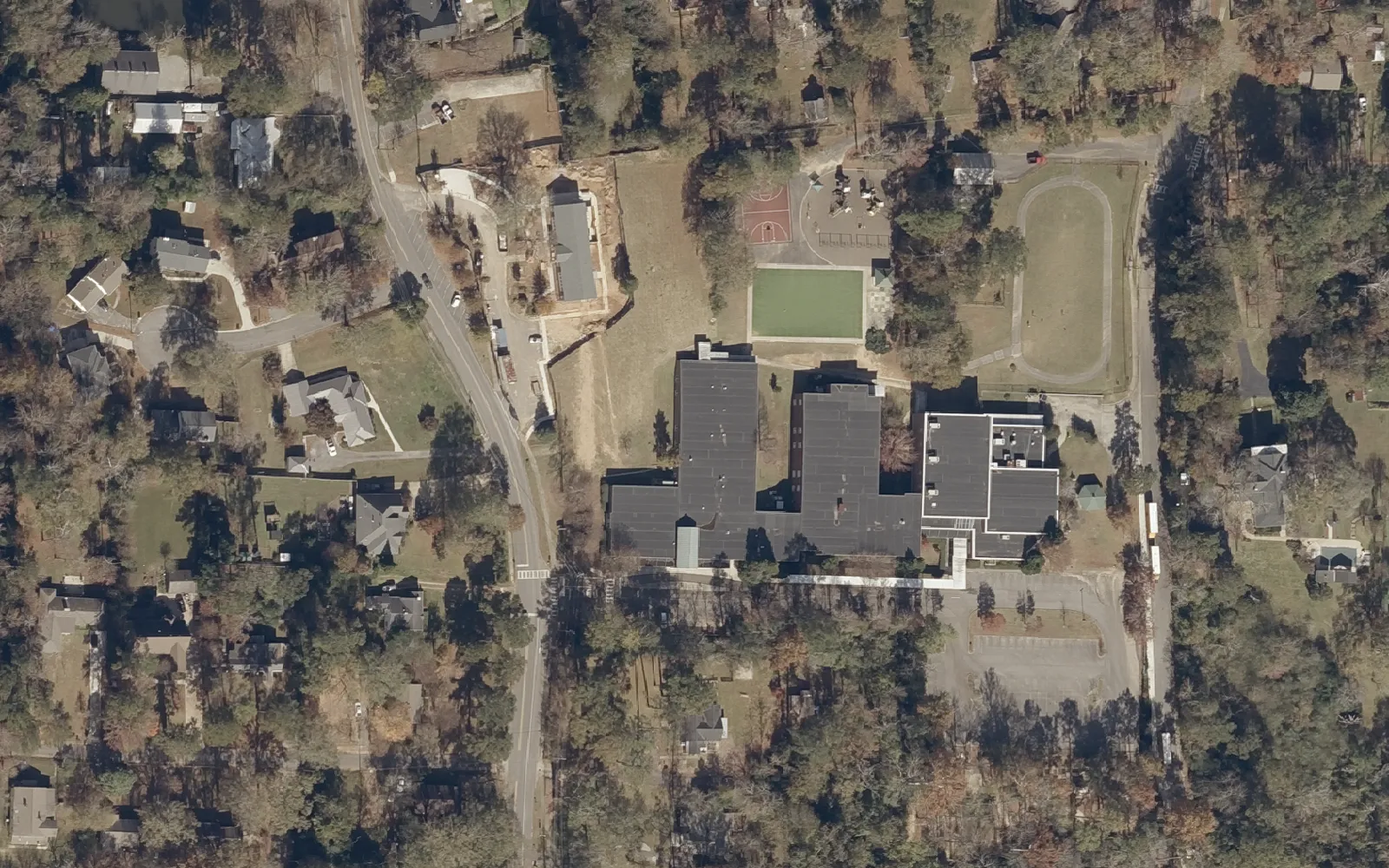 Aerial view of Bluff Park Elementary School and the wooded streets around it on top of Shades Mountain in Hoover.