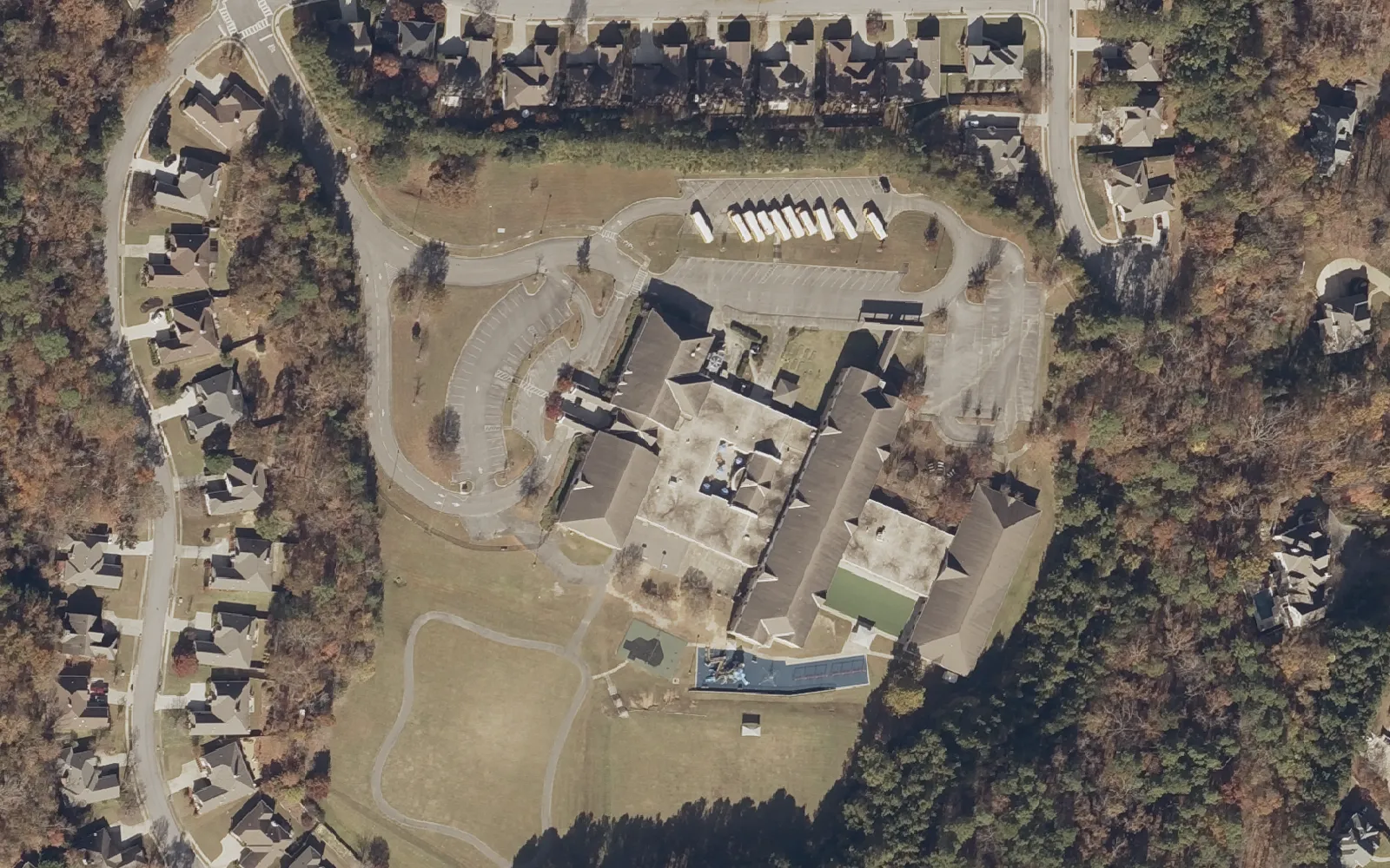 Aerial view of Greystone Elementary School on Village Street in the Shelby County part of Hoover, ringed by homes and woods.