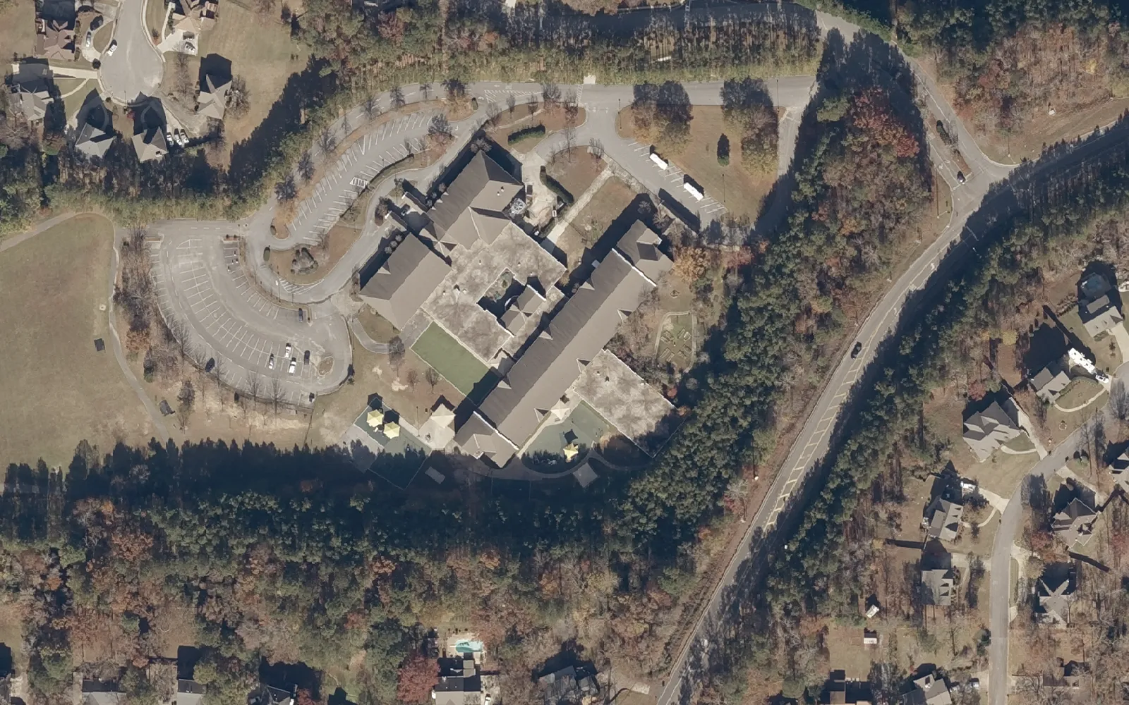 Aerial view of South Shades Crest Elementary School on South Shades Crest Road in Hoover, with its bus loop and the woods behind it.