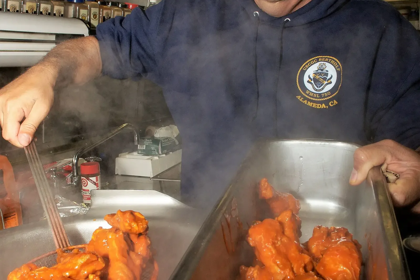 A plate of Buffalo chicken wings with celery and dipping sauce, photographed for the U.S. Coast Guard.